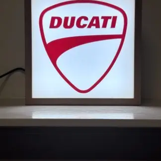 Front view of Ducati illuminated lightbox, 150mm square, engraved Ducati shield with warm LED glow