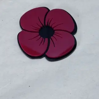 Two-layer acrylic poppy 7.7cm x 7.5cm with red top layer and black base layer, laser-cut by Boon Hill