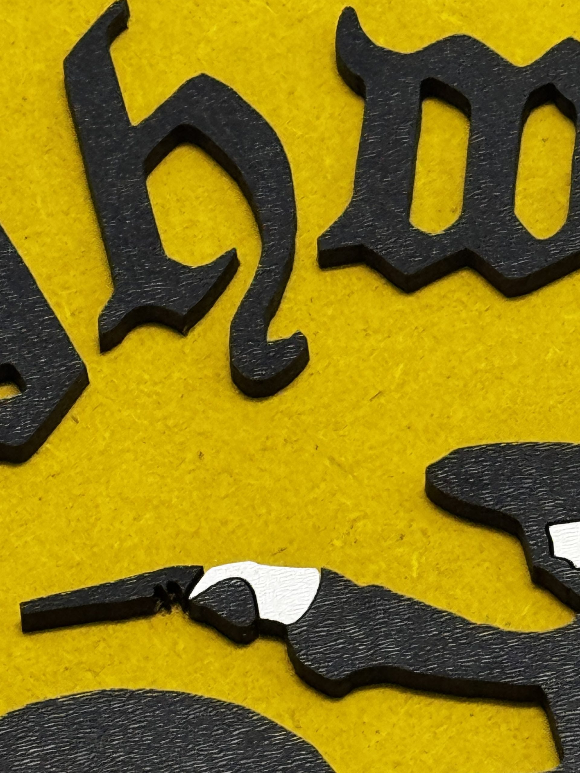Angled view of Highwayman silhouette plaque showing raised detail