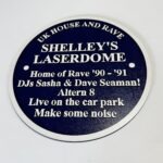 Blue and silver heritage-style commemorative plaque celebrating Shelley's Laserdome, iconic UK house and rave venue of 1990-91, featuring references to Sasha, Dave Seaman and Altern 8.